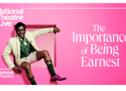 Nt live poster for the importance of being earnest a man sits on a square ledge on a vibrant pink background