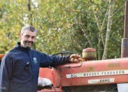 Brendan fiorbhia farmer stands beside his tractor