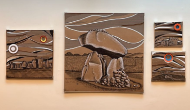 Image of greg hallahans artworks which are 4 different sized pieces all made from recycled cardboard collages depicting different anciet irish monuments dolmens and stone circles