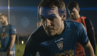 Man in a GAA jersey close up in action