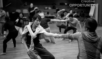 Room of people doing a physical activity y holding each other by the arms and title creative opportunity
