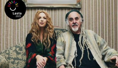 Lisa Lambe and steve cooney sit on a couch