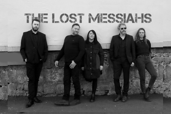 Image of the 5 band members from The Lost Messiahs band standing against a wall in black and white