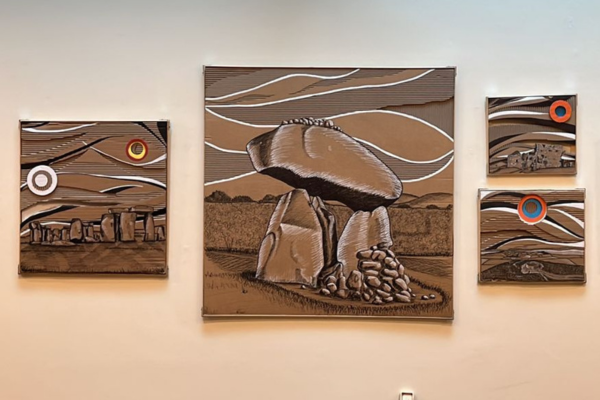 Image of greg hallahans artworks which are 4 different sized pieces all made from recycled cardboard collages depicting different anciet irish monuments dolmens and stone circles