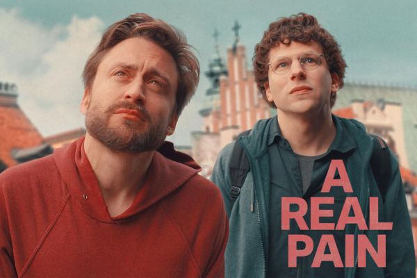 A real pain film poster showing 2 men played by kieran culkin and jessie eisenberg looking up at something in the distance